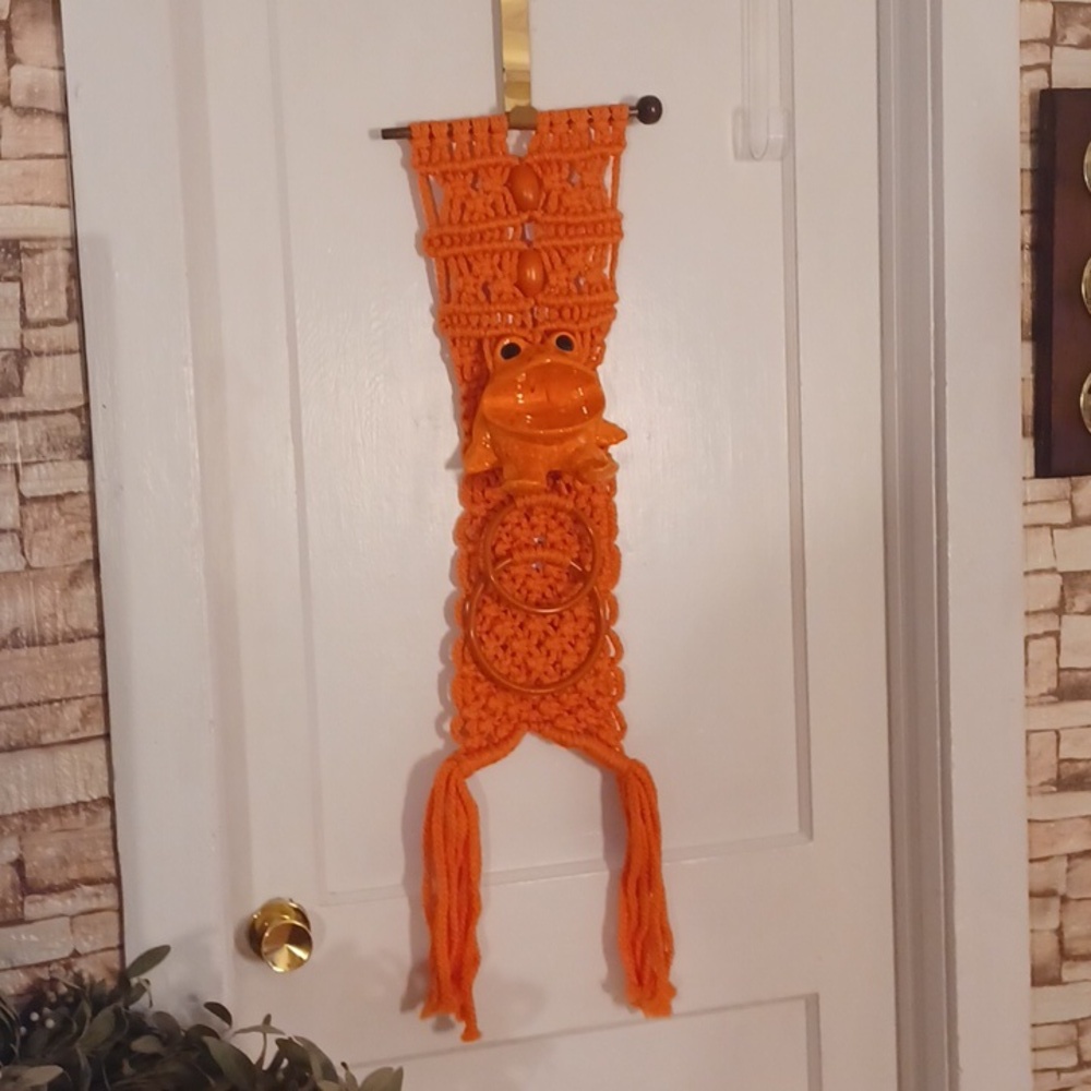 Vintage macrame towel holder with a ceramic frog orange bathroom decor
